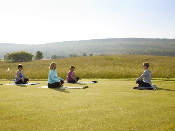 a group of people sitting on the grass