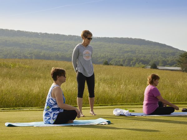 a group of people sitting on a grassy field