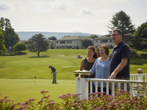 Couple overlooks golf course on tour of community