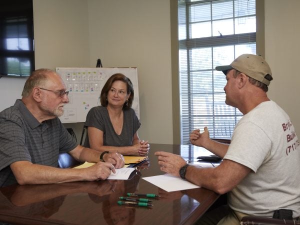 Couple discusses home features with the builder