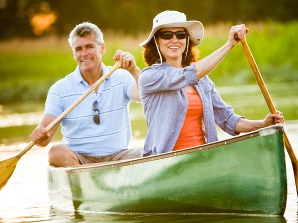 a man and a woman in a canoe