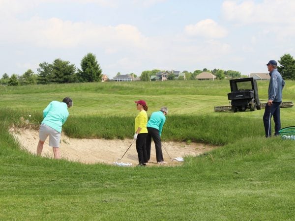 a group of people working on a field