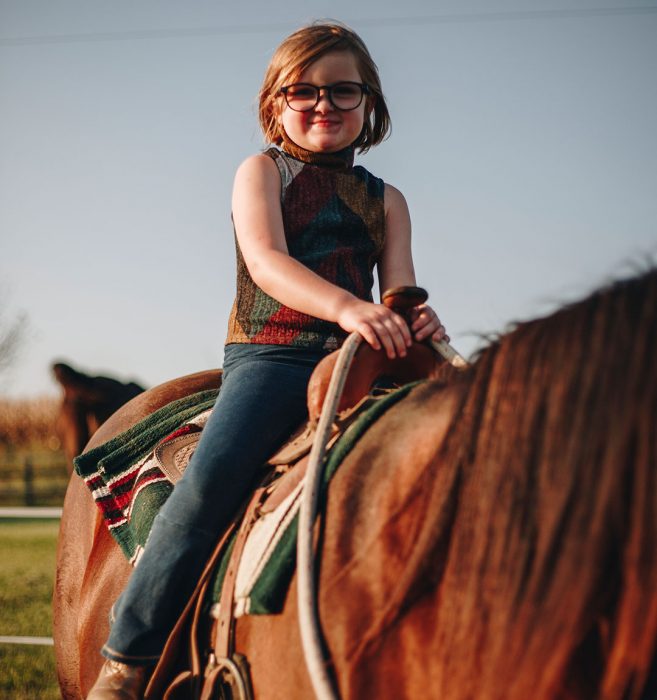 a woman riding a horse