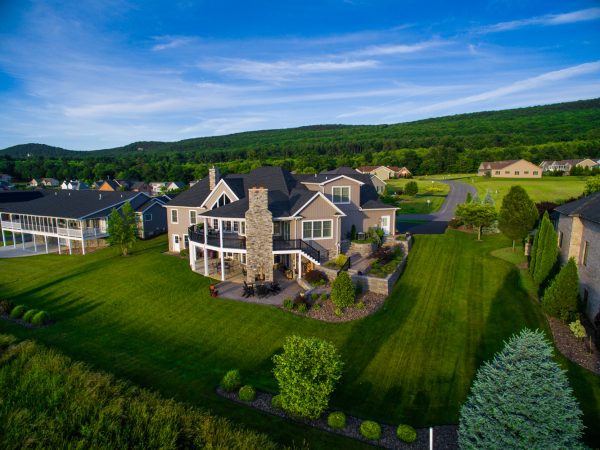 a large house with a green lawn