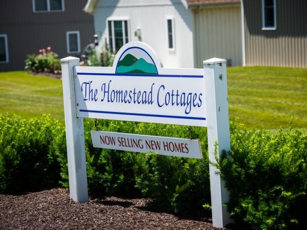 a sign in front of a house