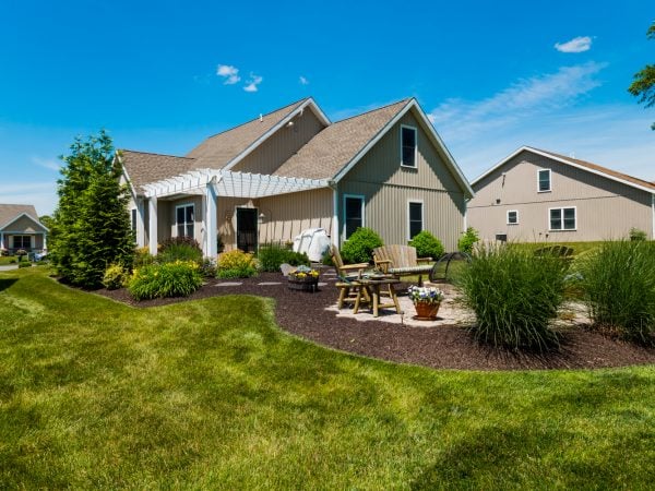 a house with a yard and a table and chairs