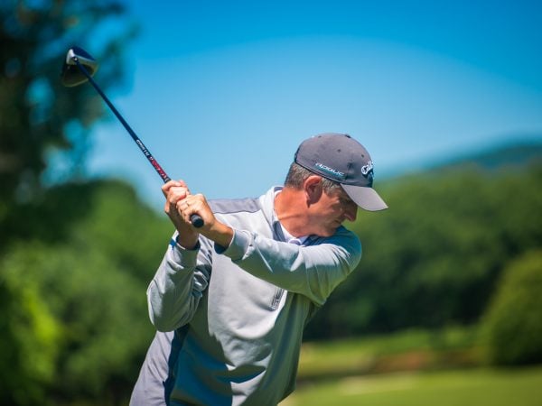 a man swinging a golf club