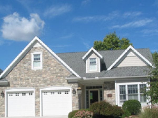 a house with a garage and trees