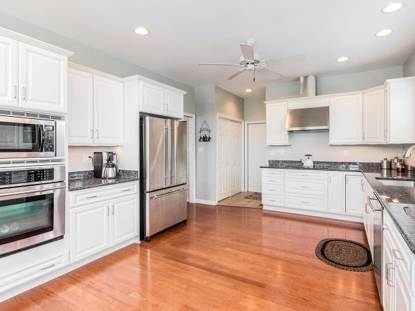 a kitchen with white cabinets