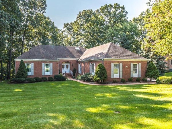 a large brick house with a lawn