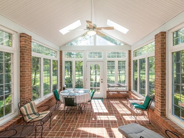 a room with a table chairs and a ceiling fan