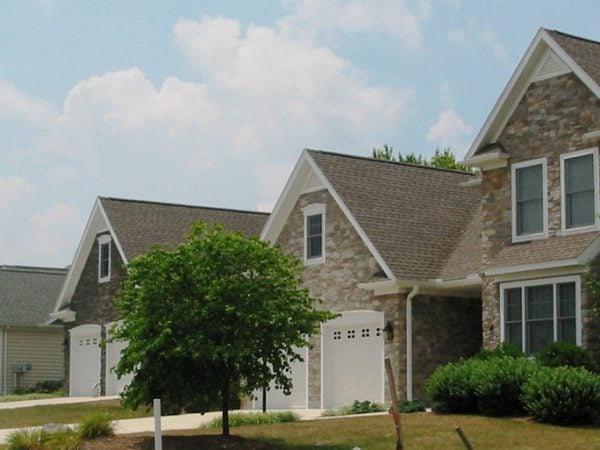 a large house with a tree in front of it