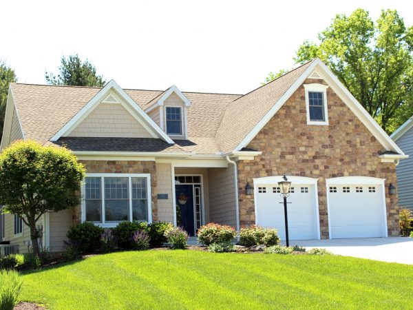 a house with a large front yard with American Gothic House in the background